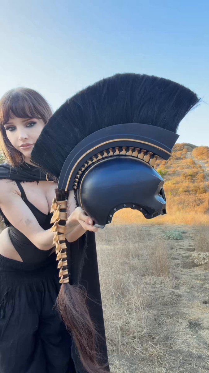 Woman in Spartan Helmet Poses Outdoors