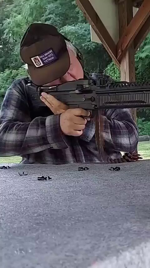 Man reacts to shooting a gun