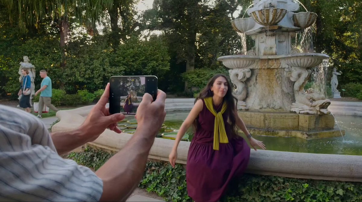 Person posing for a photo using a smartphone